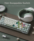 Gasket Mount 60 Percent Wired Mechanical Keyboard Hits Different With Hot Swap Linear Switches Smooth Pbt Keycaps And Rgb Backlight And Programmable Knob For Your Desk, set on wood surface with headphones.