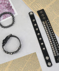 Set Of Four Badass Punk Studded Leather Bracelets For Men And Women Adjustable Spike Rock Goth Emo Y2K Grunge Wrist Cuffs on a flat surface.