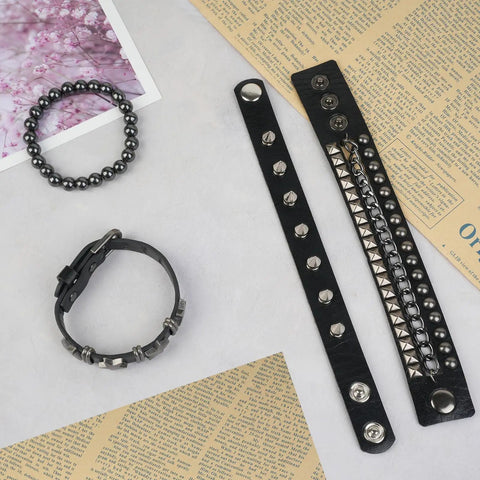 Set Of Four Badass Punk Studded Leather Bracelets For Men And Women Adjustable Spike Rock Goth Emo Y2K Grunge Wrist Cuffs on a flat surface.