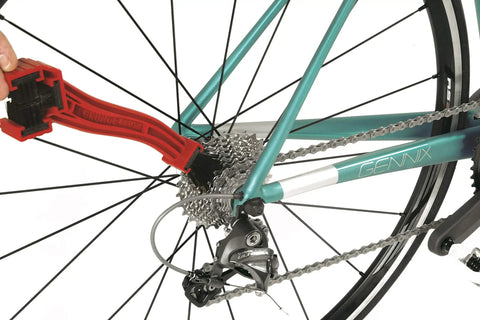 Grunge Brush Bike Chain And Gear Cleaner With Dual Sided Bristles cleaning bike gears and derailleur on teal frame