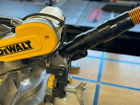Image of a Two And A Half Inch Hose Adapter For Miter Saws Quick Hookup And Easy Dust Collection Connection Fits Models DWS713 DWS715 DW716 DWS716 DWS779 DWS780 DCS781B DHS790 Made In USA installed on a DeWalt miter saw.