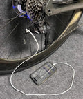 Type C Battery With Lanyard For 12 Speed E Bike Replacement Adapter connected for on the go charging, phone on grey carpet