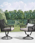 Outdoor Swivel Dining Chairs Set Of 2 With Cushions All Weather Wicker Patio Chairs Made From Twisted PE Rattan Metal Frame Swivel Seats For Lawn Or Garden Black And Light Gray, chairs shown in side profile on patio with trees in background.