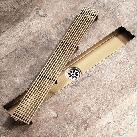 Real Deal Linear Shower Drain In Toughened Stainless Steel With Removable Hair Catcher Grate Rapid Drain Design For Bathroom Floors No Sweat Cleaning And Green Bronze Finish viewed from above, showcasing linear grate and drain.