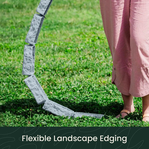 Person sets up Greystone Faux Stone Landscape Edging Kit, showing flexible 48-inch sections on grass