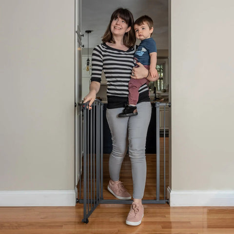 Extra Tall Decor Safety Gate For Kids And Pets In Gray Fits Openings From 28 To 38.25 Inches Wide And 36 Inches High Perfect For Doorways Stairways And Between Rooms No Fuss Install With Extensions And Stair Kit installed in doorway with woman and child.