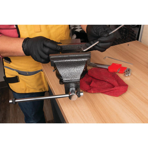 Person using Hammer Tough 8 Inch Bench Vise With Powder Coated Finish, 360 Degree Swivel Base on wood table