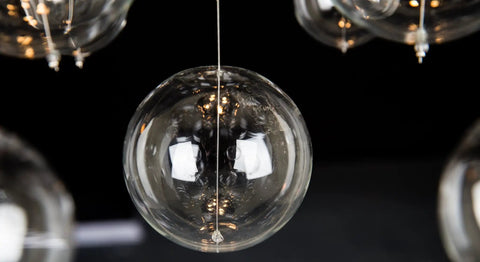 Close-up of glass sphere detail on Five-Light Modern Crystal Chandelier With Spiral Raindrop Style Pendant Light Flush Mount Ceiling Fixture.