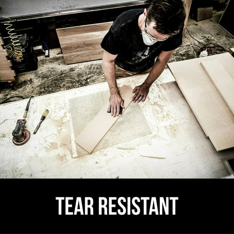 Woodworker using Pro Grade 9x11 Purple Sandpaper Set Of 20 120 Grit Clog Resistant Abrasive on workbench, tear resistant