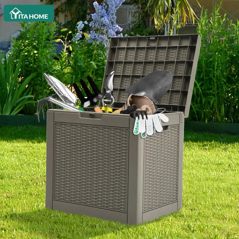 32 Gallon Rattan Deck Box With Lockable Lid And Side Handles, filled with garden tools, on green grass, weatherproof resin, brown