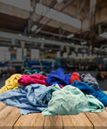 Color Knit Cleaning Rags 25 Lb Box Multipurpose Cotton T Shirt Rags for Auto Shops Workshops Mechanics Painters and Home Use Low Lint Absorbent for Oil Spills and General Cleaning on wooden table.