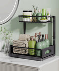 No Sweat Heavy Duty Under Sink Organizer Two Pack L Shaped Metal Pull Out Drawers For Kitchen Cabinets displayed with towels and bottles.