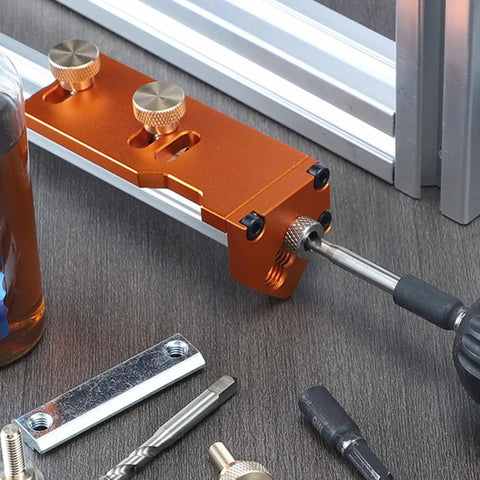 Rock Solid Aluminum Extrusion Drill Jig Snag This Easy Fit Precision Cutting Guide close-up showing orange base and drill bit attachment.