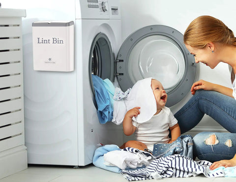 Lint Bin With Lid For Laundry Room, Small Magnetic Wall Mount Trash Can on dryer next to child and parent in warm white laundry area