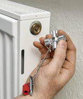 All-in-One Universal Control Cabinet Key for Gas, Water and Electric Shutoffs near a radiator knob