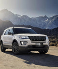 SUV with American Flag Front Bumper License Plate With 3D Embossed Patriot Design in mountain landscape