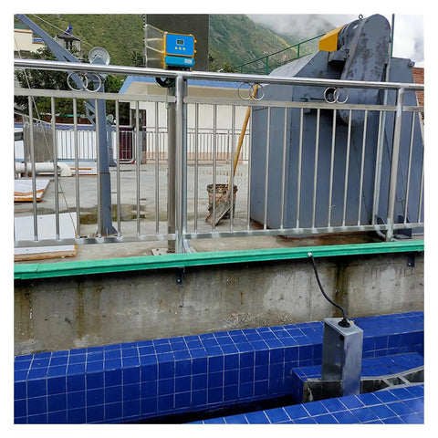 Ultrasonic Liquid Flow Meter For Open Channel And River Water installed with non-contact flow sensor on blue tiled surface.
