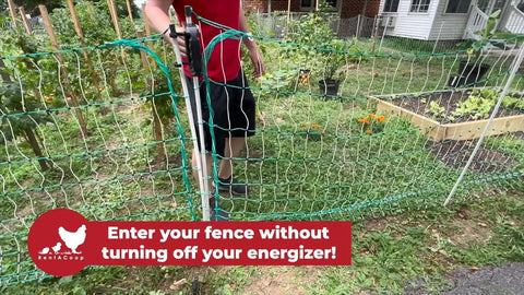 Electric Poultry Netting Accessory Set With 0.38J Solar Fence Charger and Gate Handle Kit setup near a garden