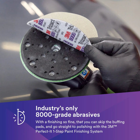 Trizact Hookit Foam Backing Abrasive Disc 8000 Grade for Collision Repair, polishing action on 6-inch disc held by gloved hand.