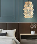 FOREVER BAMBOO Handwoven Indonesian Bamboo Pendant Light, 18 in H x 12 in W hangs above a modern bed in a stylish room.