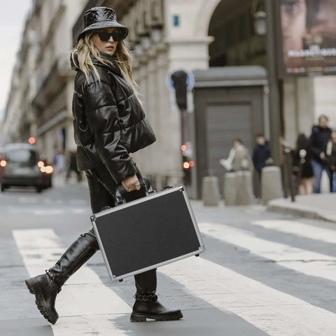 Woman holding a 14 Inch Hard Shell Carrying Case Built Tough For Cameras Lenses Guns And Tech on street.