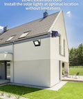 Modern house with Outdoor Solar Flood Lights Set Weatherproof Dusk To Dawn LED Security Wall Lights on corner, 16.4 ft cable visible.