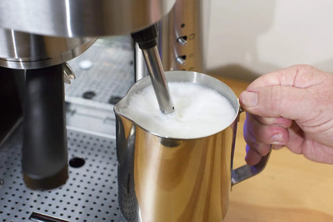 Top Tier Stainless Steel Espresso Machine With Reliable 19 Bar Italian Pump And Quick Ground Or ESE Pod Brewing Featuring Precise Temp Control And Zero Frustration Pre Brew For Killer Daily Coffee Routines milk frothing pitcher in use