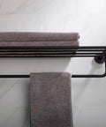 Elie Matte Black Bathroom Shelf With Towel Bar Built Tough From Solid Brass holding folded towels, wall-mounted