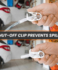 Hands holding the Portable Hand Fuel Transfer Pump Siphons Gasoline And Diesel Fast Up To Three Point Five Gallons Per Minute With Nine Foot Hose Brass Tip Weight And Pinch Clip Go To Gear For Cars Boats Mowers And Home Emergency Use with shut-off clip in a garage.