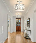 Three Light Flush Mount Ceiling Light In Brushed Nickel With A Modern Drum Design And Double Shade in a hallway setting