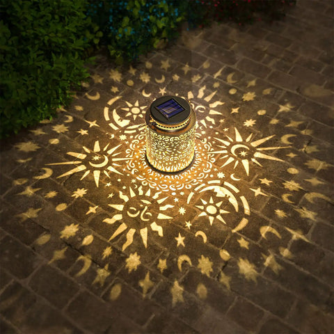 2 Pack Outdoor Solar Lanterns With Hanging Lights Waterproof Metal Sun Moon Star Pattern In Gold Finish on patio displaying light pattern