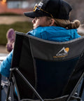 Woman seated in Ultra Easy Fold Up Outdoor Camping Chair For Adults With Mesh Back And Wide Seat Sturdy Powder Coated Steel Frame Portable