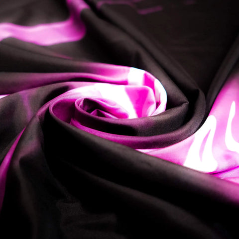 Close-up of Bad Bitches Only Neon Wall Tapestry fabric in swirling pink and black pattern.