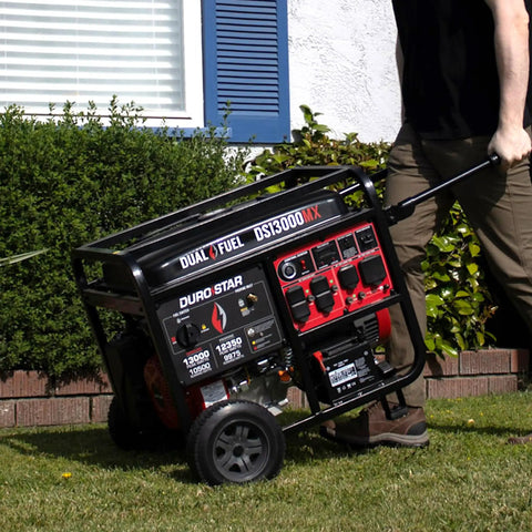 Man moving 13,000-Watt Dual Fuel Portable Generator With 500cc Engine And Remote Electric Start Powering Your Home Or RV