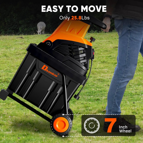 Person moving Beast Mode Wood Chipper Shredder for Yard Cleanup with 1800W motor and 1.77 inch cut, showcasing portability.