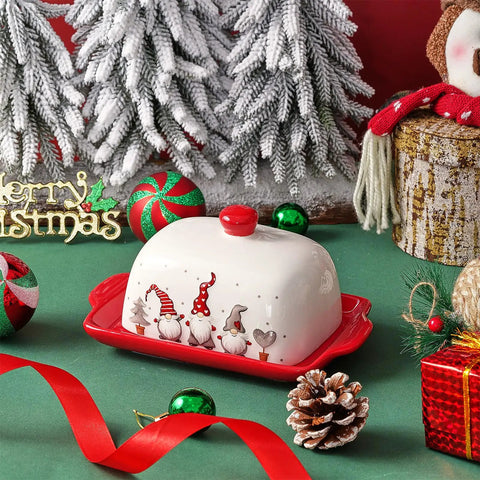 Festive Christmas Butter Dish With Tight Sealing Lid, Solid Ceramic Gnome Keeper For Kitchen Countertops on green table with holiday decor.