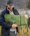 Man holding Tough As Nails Heavy Duty Survival Blanket With Reflective Thermal Layer For Camping And Outdoor Gear Waterproof