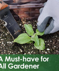 Workhorse Hori Hori Garden Knife With Sheath for weeding, 7 inch stainless steel blade, being used next to plant in soil.