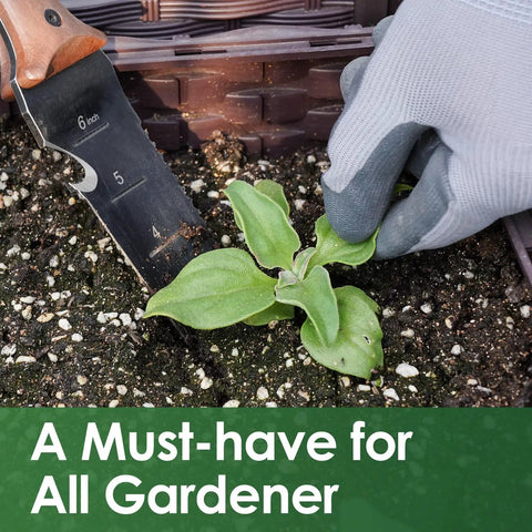 Workhorse Hori Hori Garden Knife With Sheath for weeding, 7 inch stainless steel blade, being used next to plant in soil.
