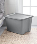 Built Tough Eighteen Gallon Storage Bin With Secure Snap Lid Heavy Duty Stackable Tote For Clutter Control Hella Roomy Gray Plastic Organizer next to bed.