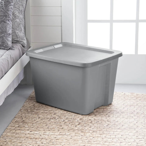 Built Tough Eighteen Gallon Storage Bin With Secure Snap Lid Heavy Duty Stackable Tote For Clutter Control Hella Roomy Gray Plastic Organizer next to bed.