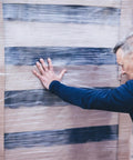 Man inspecting a pallet wrapped in Heavy Duty Cast Stretch Wrap And Shrink Film For Pallet Wrapping Machines 19.7 Inch By 5000 Ft 75 Gauge.