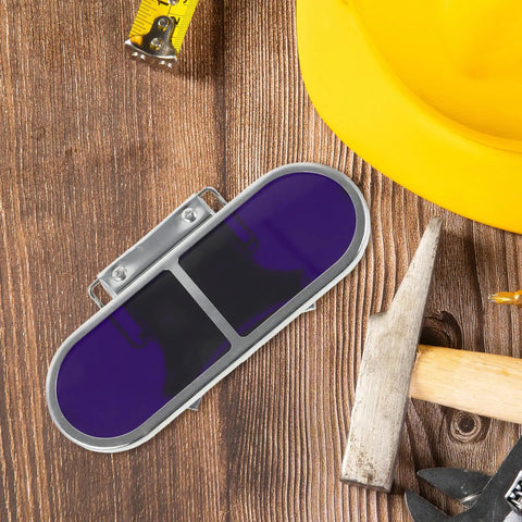 Industrial Welding Goggles Featuring A Quick Flip Up Lens And Secure Metal Clip Frame built for tough sheetmetal jobs on wood surface.