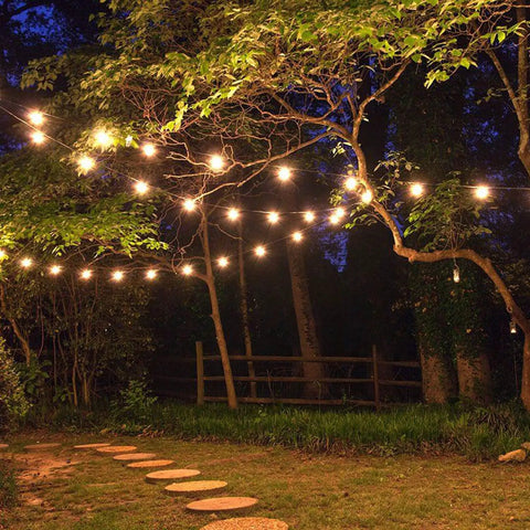 Solar String Lights Waterproof Indoor Outdoor Hanging Umbrella Lights With 25 Bulbs And 27 Ft Patio String For Deck Yard Porch Market Cafe Party Vibes Decor illuminating a forest path.