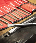 12 Piece Punch And Chisel Chrome Set For Pros And DIYers, close-up of chisels with durable chrome finish on a textured surface.