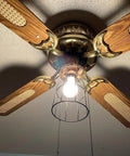 Premium Black Metal Wire Cage Lamp Guard For Ceiling Fans And Pendant Lights Killer Diamond Shape Light Cover With Slick Rust Resistant Coating Set Of Two, mounted on ceiling fan with wooden blades.