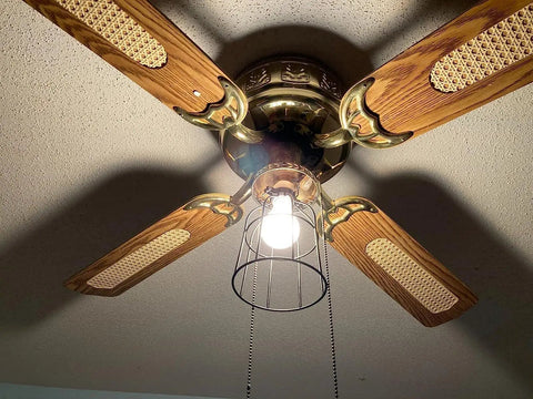 Premium Black Metal Wire Cage Lamp Guard For Ceiling Fans And Pendant Lights Killer Diamond Shape Light Cover With Slick Rust Resistant Coating Set Of Two, mounted on ceiling fan with wooden blades.