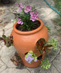 Strawberry Jar Planter With Twelve Side Openings For Herbs Flowers And Succulents Durable Lightweight Terra Cotta Colored Plastic Garden Container featuring blooming flowers outdoors