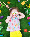 Child playing on grass surrounded by the Six Piece 8 Inch Kids Garden Tools Set With Metal Shovels And Wooden Handle For Beach Sandbox Snow Play