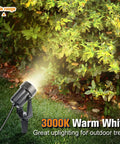 Close-up of spotlight illuminating a bush, part of 95Ft Low Voltage LED Landscape Lighting Kit With Transformer Waterproof Outdoor Lights 8 Spotlights Warm White 12W For Yard Lawn Trees Pathway And Garden Ambience That Slaps.